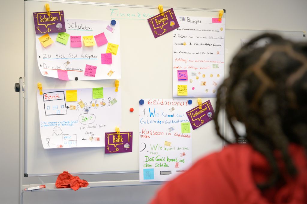 Financial education for children: A schoolgirl looks at her budget.